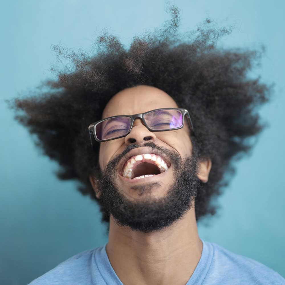 Smiling woman looking at her tax refund on laptop